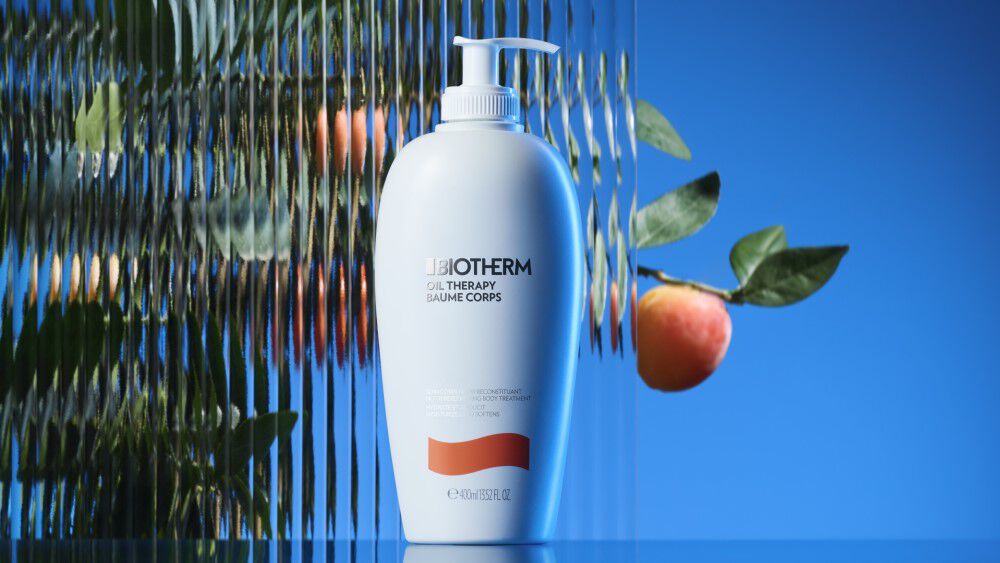 Biotherm oil therapy bottle on an apricot style background