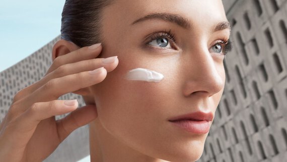 woman doing a face yoga cream application