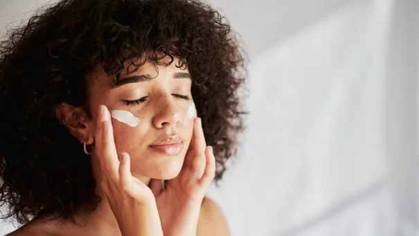 Femme qui applique de la creme anti-rides