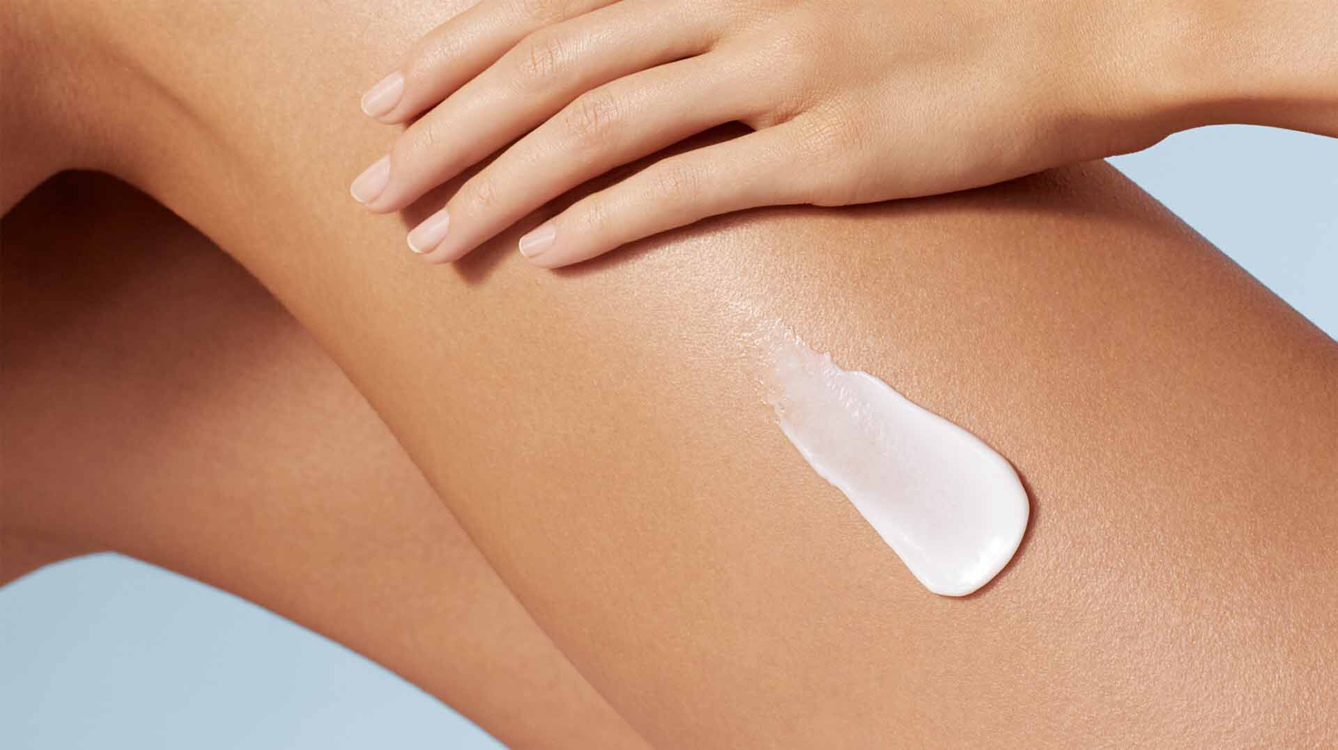 Cream for body care over 50 is applied to the thighs
