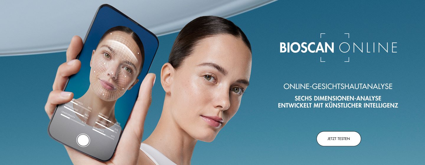 Frau hält Smartphone, Gesichtserkennung wird angezeigt. Text: "BIOSCAN ONLINE, ONLINE-GESICHTSHAUTANALYSE, SECHS DIMENSIONEN-ANALYSE, ENTWICKELT MIT KÜNSTLICHER INTELLIGENZ". Button: "JETZT TESTEN".
